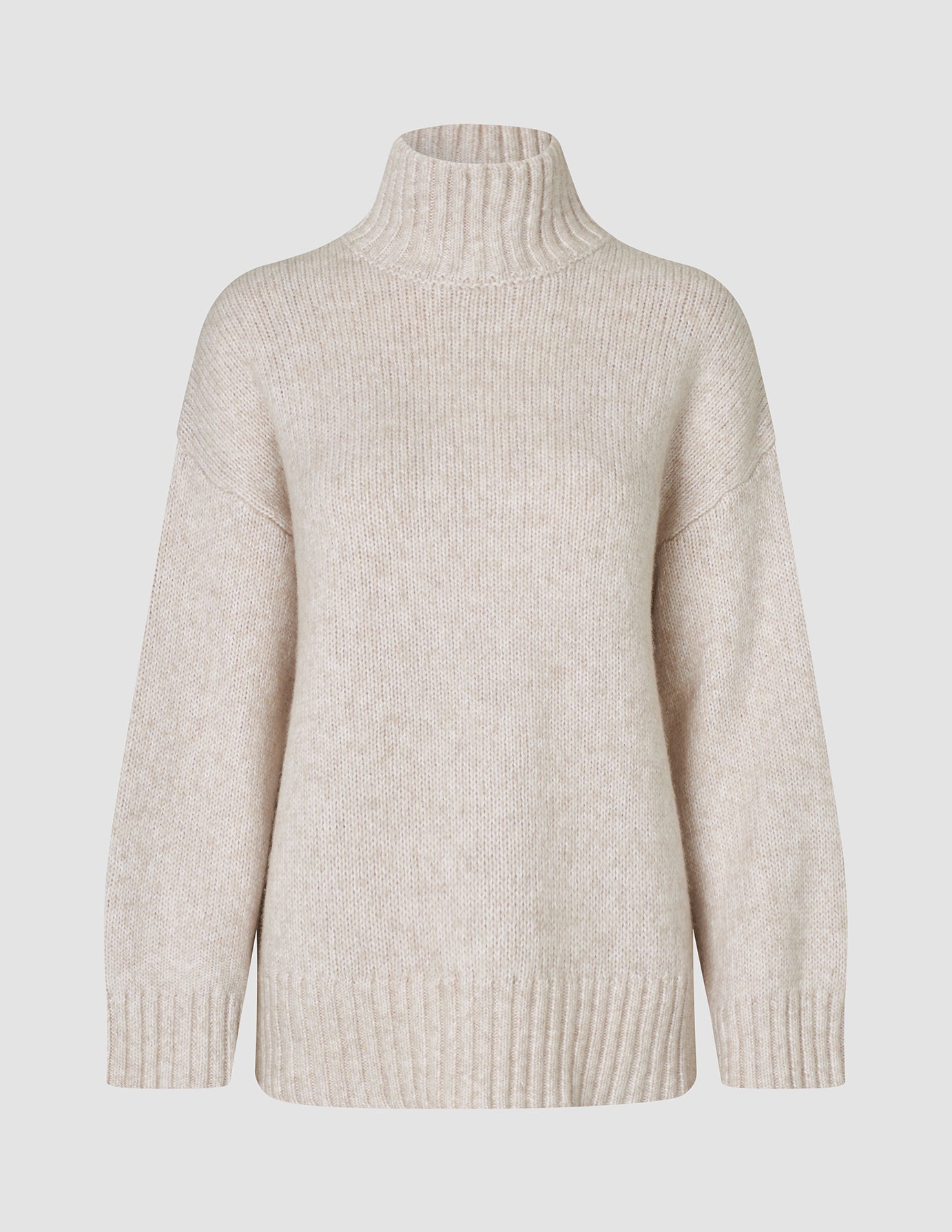 Beige damtröja i tjock, mjuk ull med hög hals, modell Sugar Melange, i merinoull med ribbad kant.